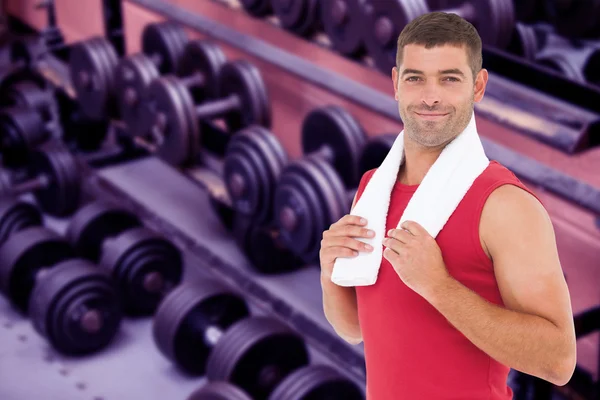 Fit man against collection of barbells