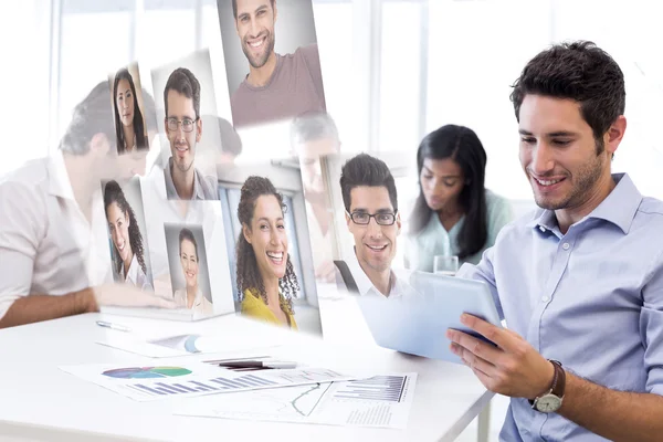 Attractive businessman using a tablet at work