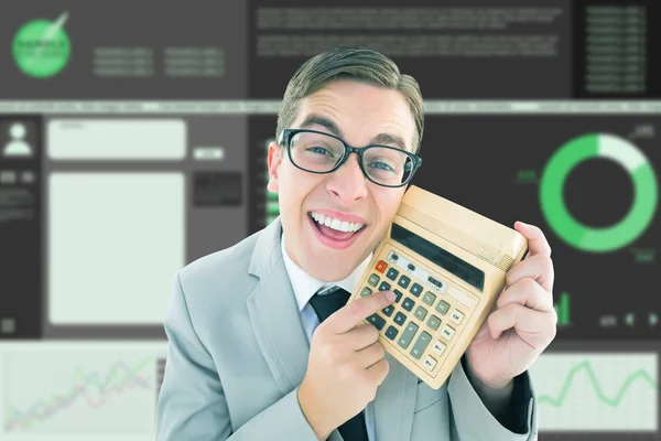 Geeky smiling businessman showing calculator