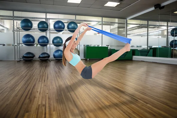 Woman exercising with a blue yoga belt