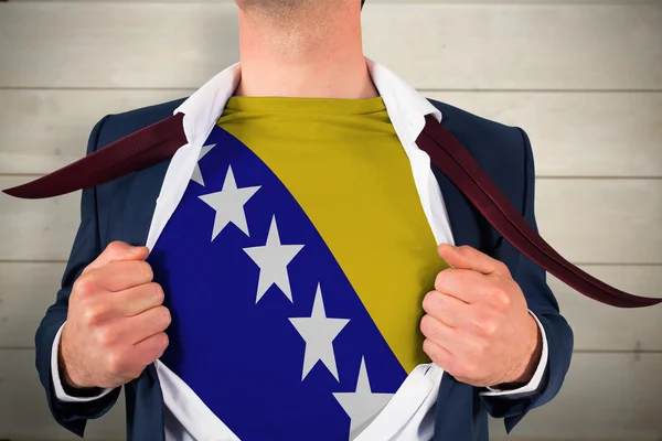 Businessman opening shirt to reveal bosnia flag