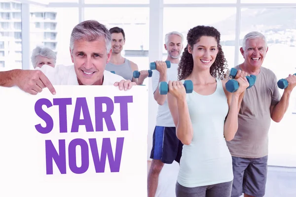 Man showing a poster against start now