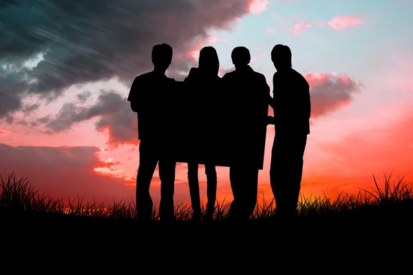 Silhouette of team holding a poster