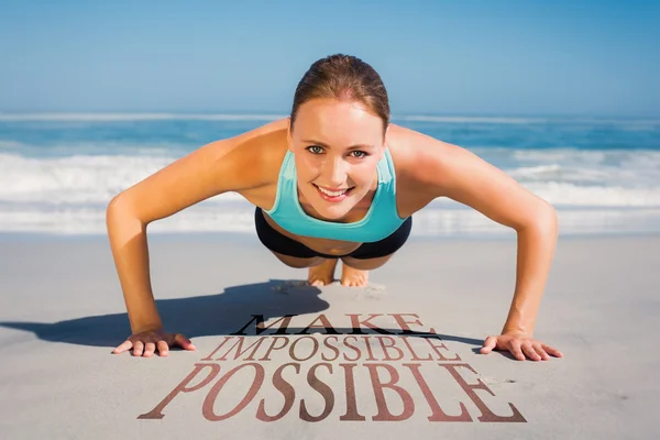 Fit woman in plank position on the beach