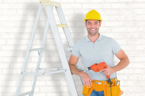 Handyman with power drill leaning on ladder