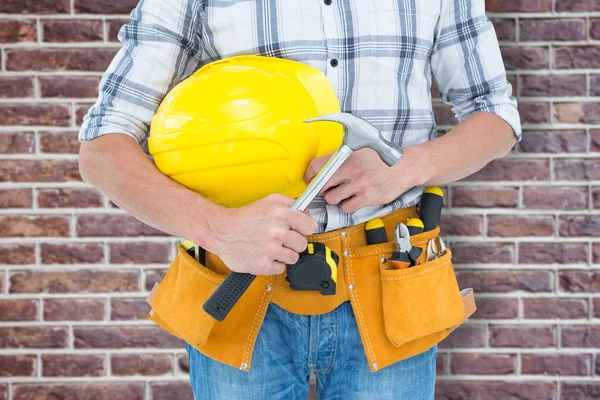 Technician holding hammer and hard hat