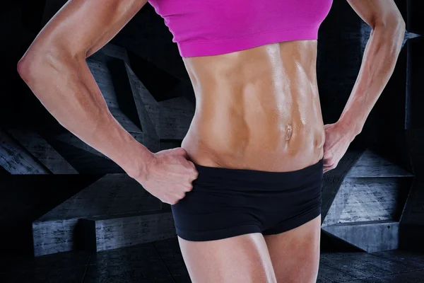 Female bodybuilder posing with hands on hips