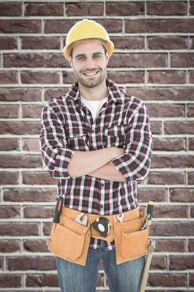 Confident male handyman wearing tool belt