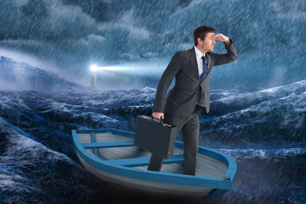 Businessman in boat against stormy sea