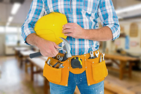 Manual worker wearing tool belt