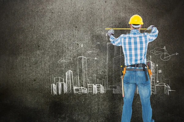 Construction worker using measure tape