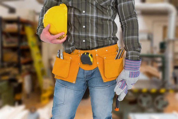 Manual worker wearing tool belt
