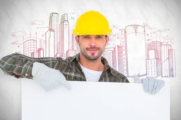 Handyman holding and pointing at blank board