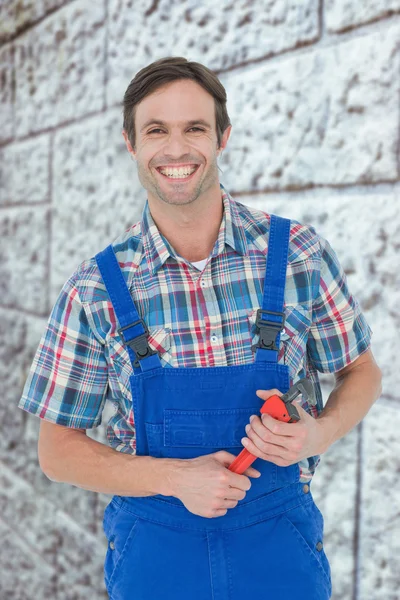 Confident plumber holding monkey wrench