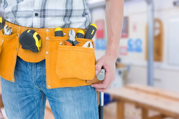 Technician with tool belt around waist