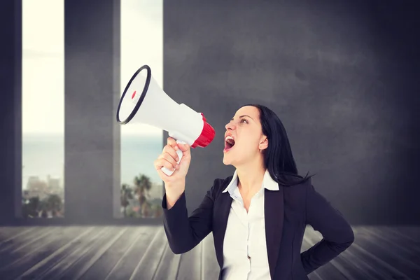 Businesswoman shouting with megaphone