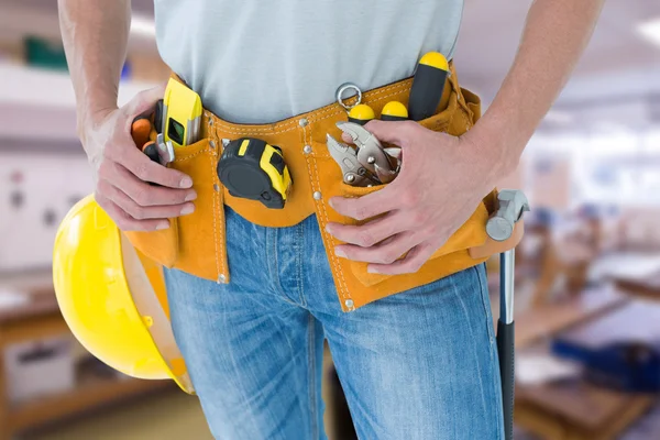 Technician with tool belt around waist