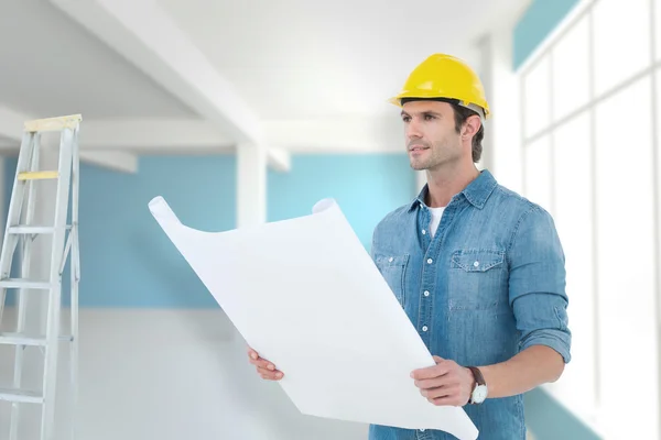 Architect holding blueprint in house