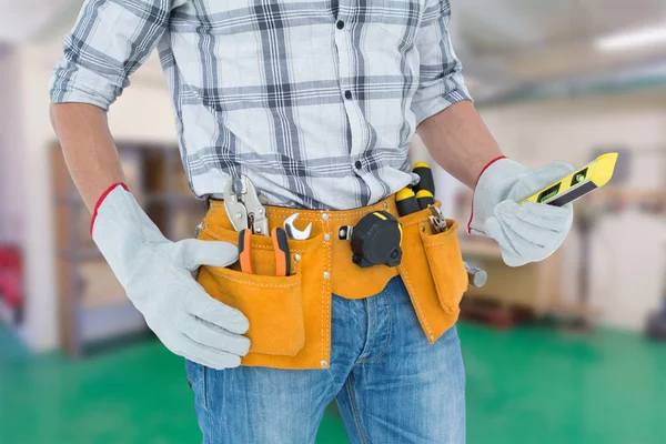 Technician with tool belt around waist