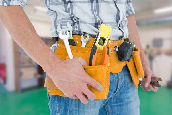 Technician with tool belt around waist