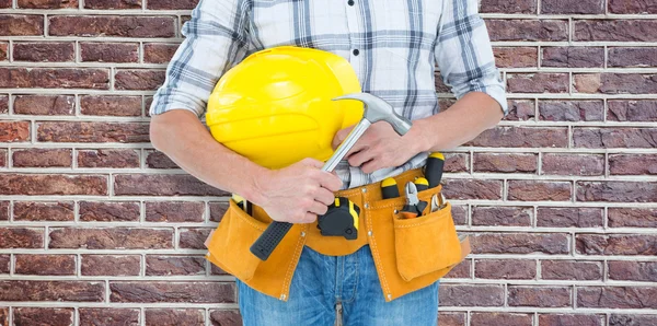 Technician holding hammer and hard hat