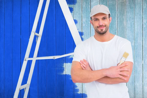 Handyman with paintbrush and ladder