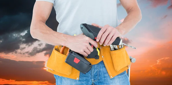 Repairman holding handheld drill