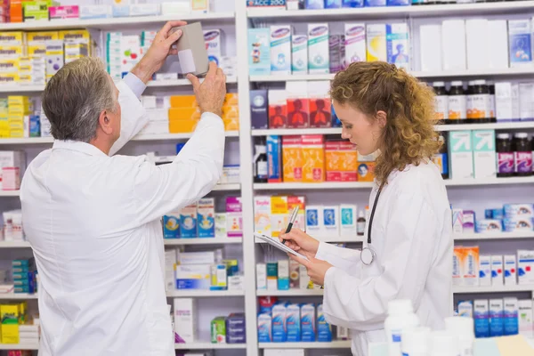 Pharmacists searching medicines with prescription