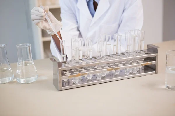 Scientist working attentively with pipette