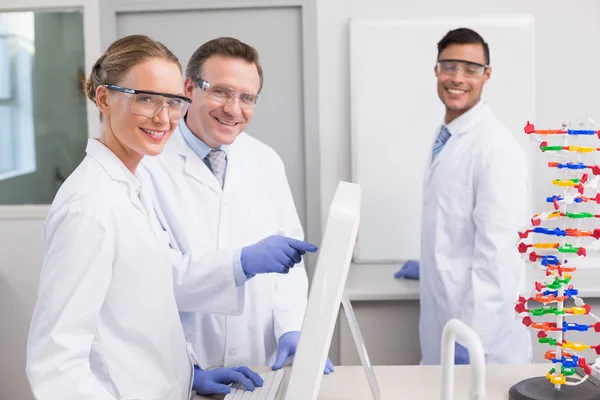 Smiling scientist working with computer