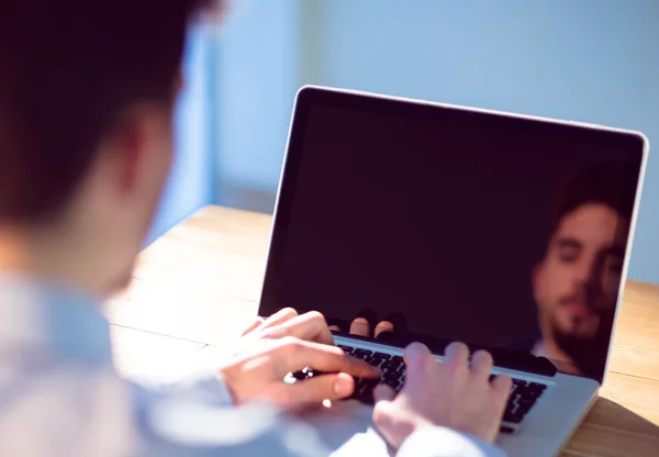 Businessman using laptop at desk