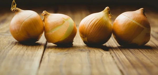 Fresh onions on wooden background