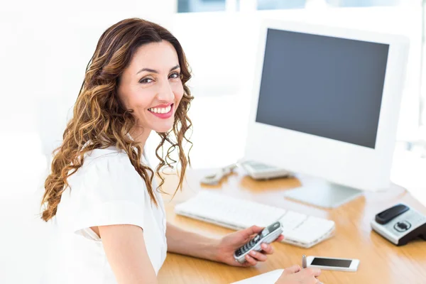 Smiling businesswoman looking at camera