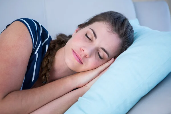 Peaceful woman sleeping on couch