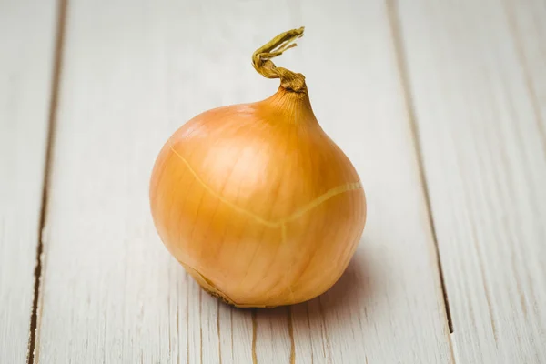 Fresh onion on wooden background
