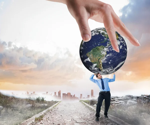 Hand holding earth and businessman