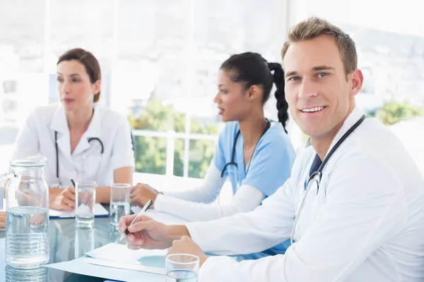 Team of smiling doctors having meeting