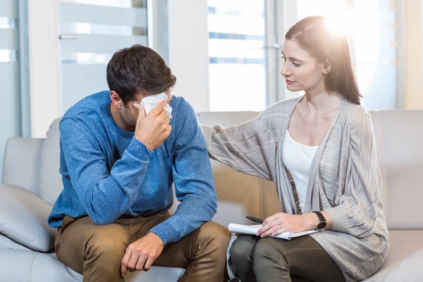 Psychologist comforting a depressed man