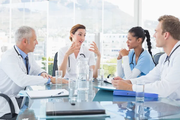 Team of smiling doctors having meeting