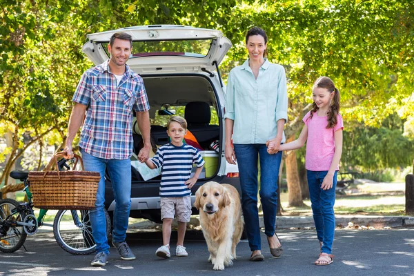 Family with dog getting ready for road trip
