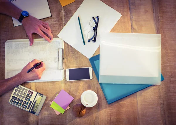 Designer working at desk overhead shot