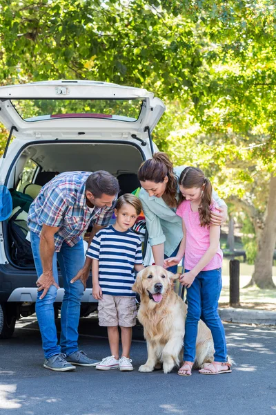 Family with dog getting ready for road trip