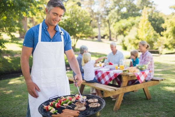 Man doing barbecue for his family