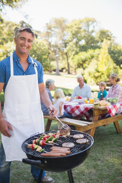 Man doing barbecue for his family