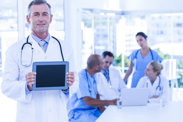 Doctor showing tablet pc during meeting