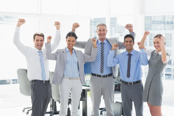 Business people cheering in office