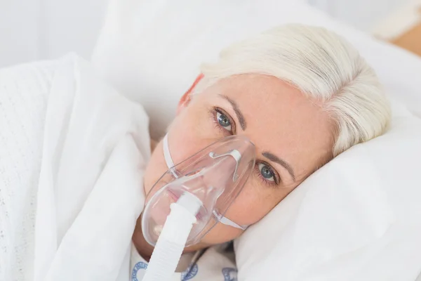 A patient with an oxygen mask