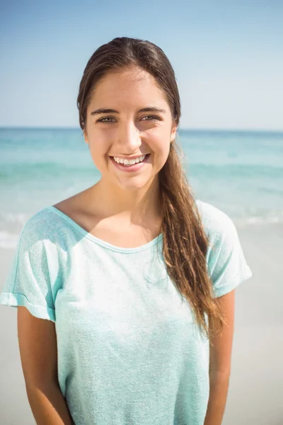 Woman smiling at camera at beach