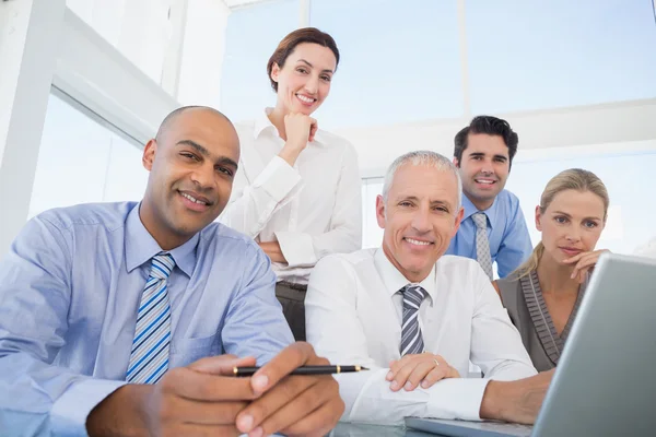 Business team during meeting smiling at camera