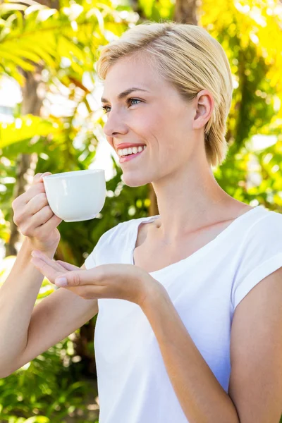 Attractive blonde woman holding mug